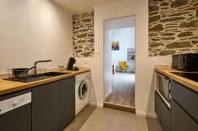 a kitchen with a sink and a washing machine at Domaine du Fresquel in Pezens