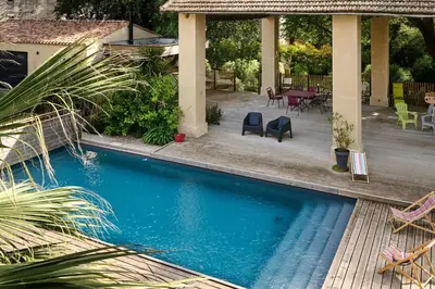 a house with a swimming pool and a patio at Domaine du Fresquel in Pezens