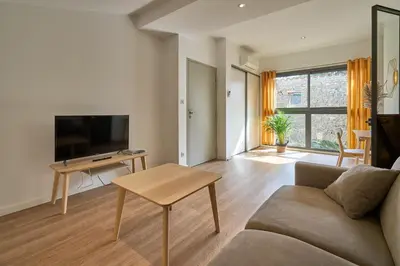 a living room with a couch and a table at Domaine du Fresquel in Pezens