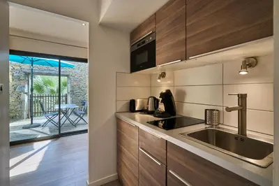 a kitchen with a sink and a counter top at Domaine du Fresquel in Pezens
