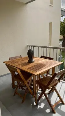 a wooden table with a statue sitting on top of it at APPARTEMENT T2 GRUISSAN PLAGE DANS RÉSIDENCE CALME in Gruissan