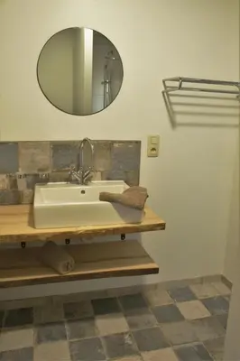 a bathroom with a sink and a mirror at Domaine de la Couderquié in Lautrec
