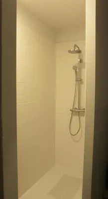 a shower with a shower head in a bathroom at Domaine de la Couderquié in Lautrec