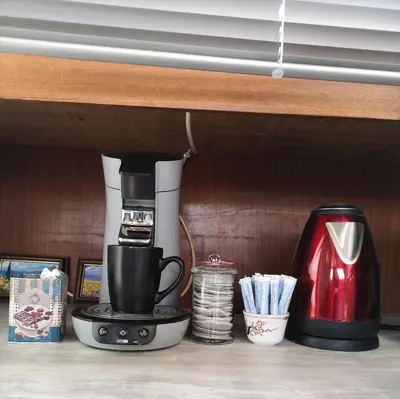 a coffeemaker sitting on a shelf with a coffee maker at Bateau Fellowship in Narbonne