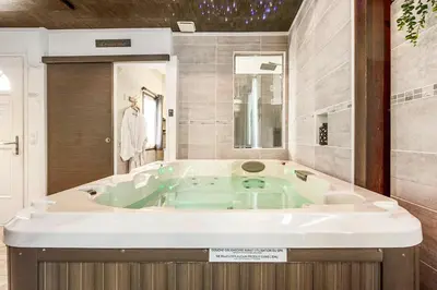 a large bath tub in a bathroom with at Love room 