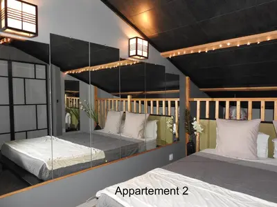 two beds in a room with lights on the ceiling at Love room 