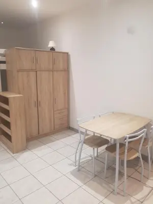 a dining room with a wooden table and chairs at keep calm in Pamiers studio indépendant in Pamiers