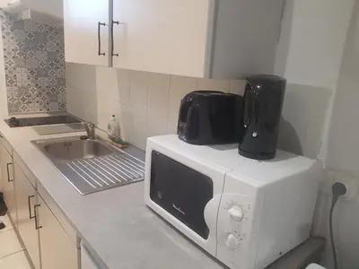 a microwave sitting on top of a kitchen counter at keep calm in Pamiers studio indépendant in Pamiers