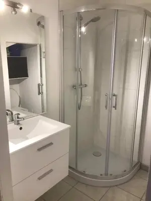 a bathroom with a glass shower and a sink at keep calm in Pamiers studio indépendant in Pamiers