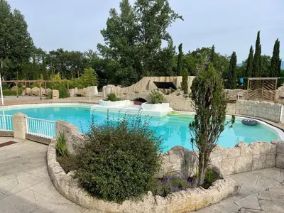 a large swimming pool in a landscaped yard at Chambre au Domaine Spa-piscine sauna in Lescout