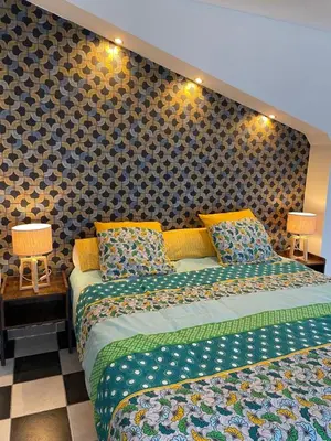 a bedroom with two beds and a wall at Chambre au Domaine Spa-piscine sauna in Lescout