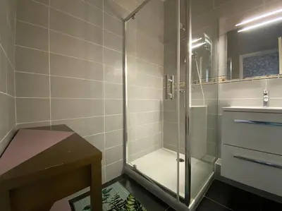 a bathroom with a glass shower and a sink at L'Appartement Jebari - Esprit loft Carcassonne proche cité médiéval et aéroport in Carcassonne