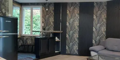 a living room with a refrigerator and a window at T2 tout confort, parking gratuit, vue lac et nature in Revel