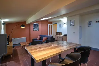a living room with a wooden table and chairs at AUTOUR DU CHATEAU in Carcassonne