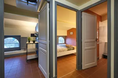 a bedroom with a bed and a tv at AUTOUR DU CHATEAU in Carcassonne