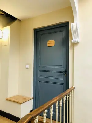 a blue door in a staircase with a sign on it at AUTOUR DU CHATEAU in Carcassonne