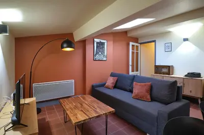 a living room with a couch and a table at AUTOUR DU CHATEAU in Carcassonne