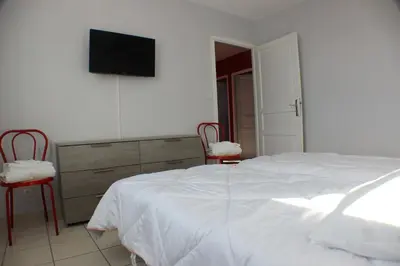 a bedroom with a bed and a dresser with a television at Chez Carole et Michel en Minervois in Rieux-Minervois