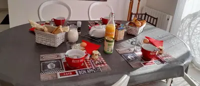 a table with food and drinks and baskets of bread at Chez Carole et Michel en Minervois in Rieux-Minervois