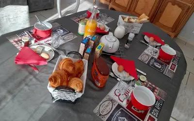a table with breakfast foods and drinks on it at Chez Carole et Michel en Minervois in Rieux-Minervois