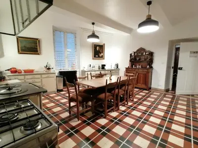 a kitchen with a table and chairs in it at MAISON ALETEIA*** DECOUVERTE ET SERENITE in Alet-les-Bains