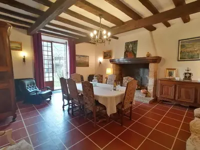 a dining room with a table and a fireplace at MAISON ALETEIA*** DECOUVERTE ET SERENITE in Alet-les-Bains