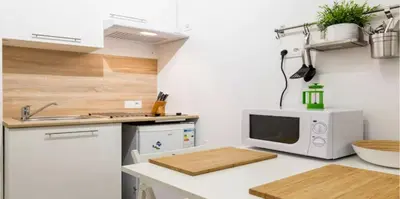 a kitchen with a microwave and a counter top at DUPLEX DU GET in Revel