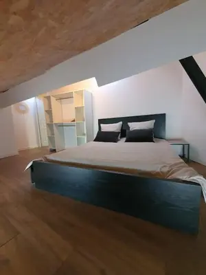 a bedroom with a large bed in a room at LOFT DU GET in Revel