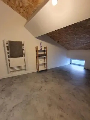 an empty room with a vaulted ceiling and a window at LOFT DU GET in Revel