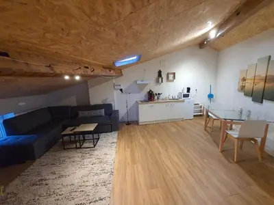 a living room with a blue couch and a table at LOFT DU GET in Revel
