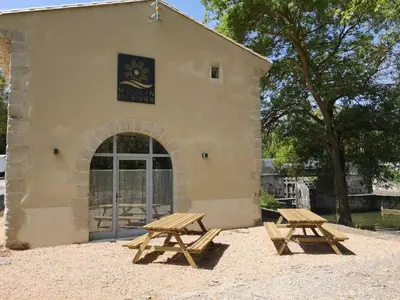 two picnic tables in front of a building at LE MOULIN DU VIVIER in Saint-Martin-Lalande