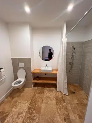 a bathroom with a toilet and a mirror at LE MOULIN DU VIVIER in Saint-Martin-Lalande