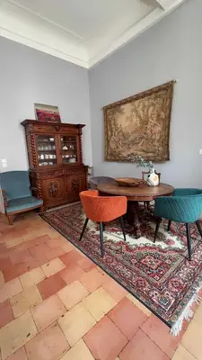 a living room with a table and two chairs at GITE Le Logis Barbès in Carcassonne