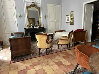 a room with a bedroom with a table and chairs at GITE Le Logis Barbès in Carcassonne