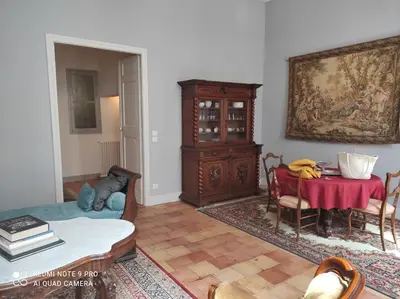 a living room with a table and a dining room at GITE Le Logis Barbès in Carcassonne