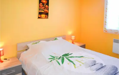 a bedroom with a white bed with two night stands and two lamps at Stunning Home In Saint-Nazaire-D'aude in Saint-Nazaire-dʼAude