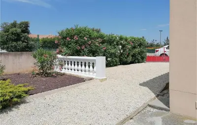 a white bench sitting in front of some bushes at Stunning Home In Saint-Nazaire-D'aude in Saint-Nazaire-dʼAude