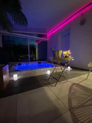 a bathroom with a tub with purple lights at Koh Samui Siam Manahakhon Appart & Spa in Rieux-de-Pelleport