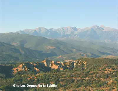 a view of a mountain range with mountains in the background at Gîte les Lauriers des orgues d'Ille - la Sybille in Ille-sur-Têt