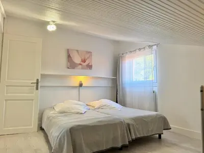 a bedroom with a bed and a window at Gîte les Lauriers des orgues d'Ille - la Sybille in Ille-sur-Têt