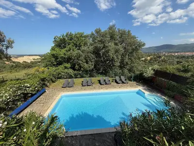 a swimming pool with chaise lounge chairs at Gîte les Lauriers des orgues d'Ille - la Sybille in Ille-sur-Têt