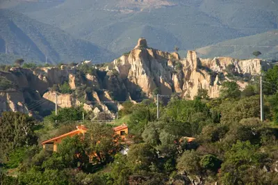 a mountain with a house in front of it at Gîte les Lauriers des orgues d'Ille - la Sybille in Ille-sur-Têt