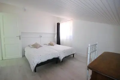 a bedroom with a bed and a window and a table at Gîte les Lauriers des orgues d'Ille - la Sybille in Ille-sur-Têt