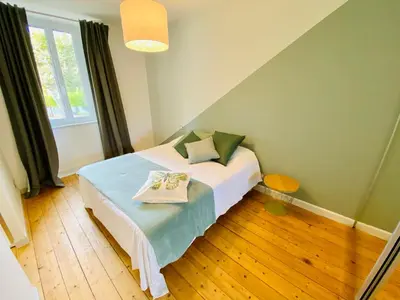 a bedroom with a bed and a large window at Gite des Platanes in Belvèze-du-Razès