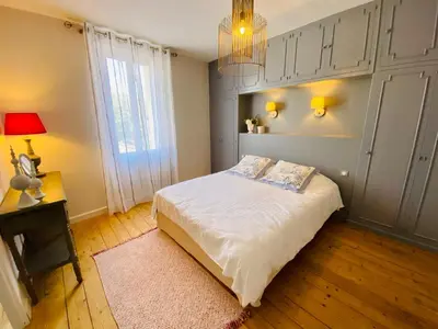 a bedroom with a bed and a chandelier at Gite des Platanes in Belvèze-du-Razès