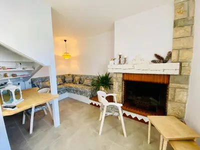 a living room with a couch and a fireplace at Gite des Platanes in Belvèze-du-Razès