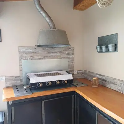 a kitchen with a toaster oven on top of a counter at Gite des Platanes in Belvèze-du-Razès