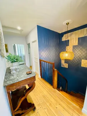 a room with a blue wall and a table at Gite des Platanes in Belvèze-du-Razès
