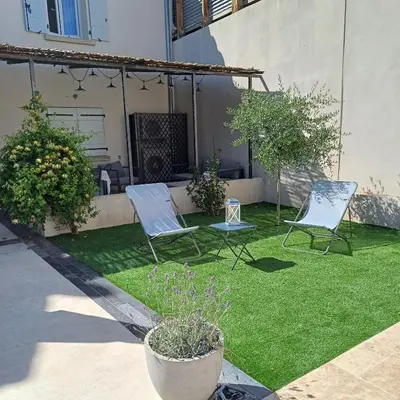two chairs and a table in a yard at Gite des Platanes in Belvèze-du-Razès