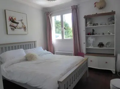 a bedroom with a large white bed and a window at La Maison Barthélemy: Voie Verte et piscine in Bellegarde-du-Razès